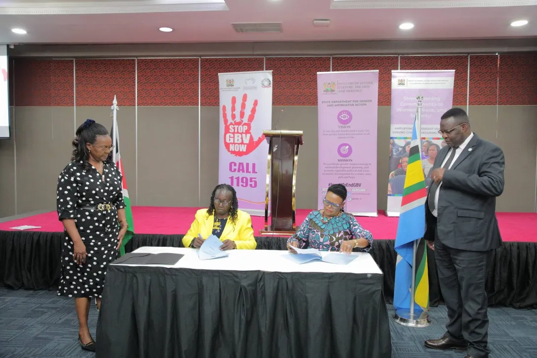Chief Justice Martha Koome and CS Hanna Wendot Cheptumo sign a joint communique to endorse Kenya's adoption of the CSW70 outcomes. Looking on are PS Anne Wang'ombe (left) and Thomas Koyier, NGEC Vice Chaiperson